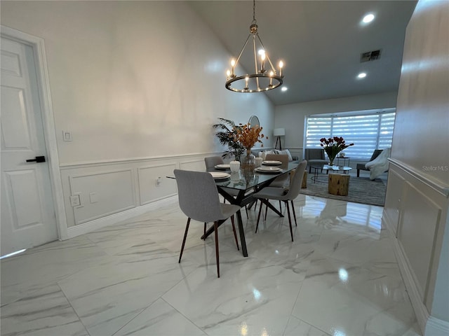 dining space featuring vaulted ceiling and a notable chandelier