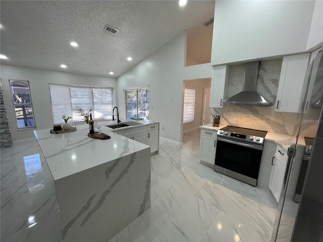 kitchen featuring light stone countertops, wall chimney exhaust hood, backsplash, sink, and stainless steel range with electric stovetop