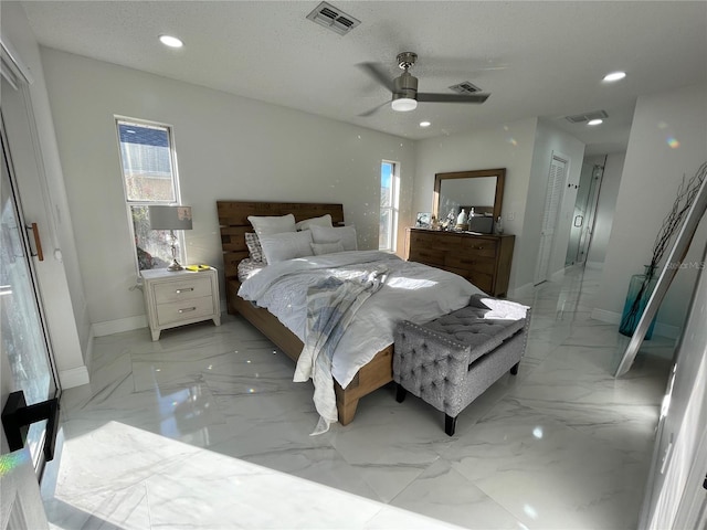 bedroom with a textured ceiling, ceiling fan, and a closet