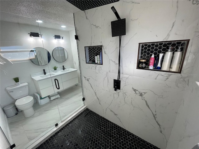 bathroom featuring a shower with shower door, toilet, a textured ceiling, and vanity