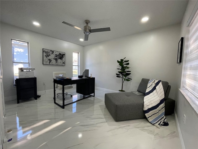 office featuring a textured ceiling and ceiling fan