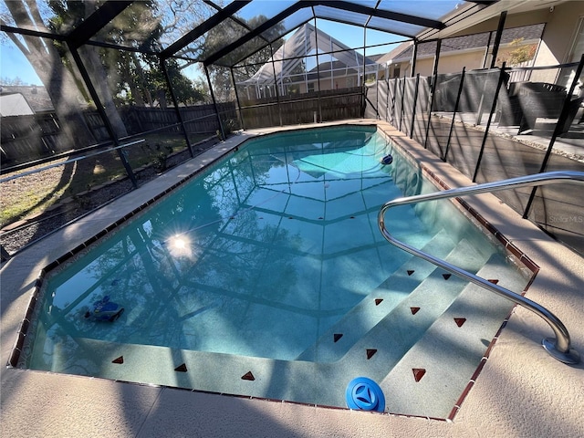 view of pool with glass enclosure