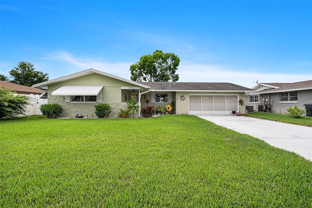 ranch-style home featuring a garage and a front lawn