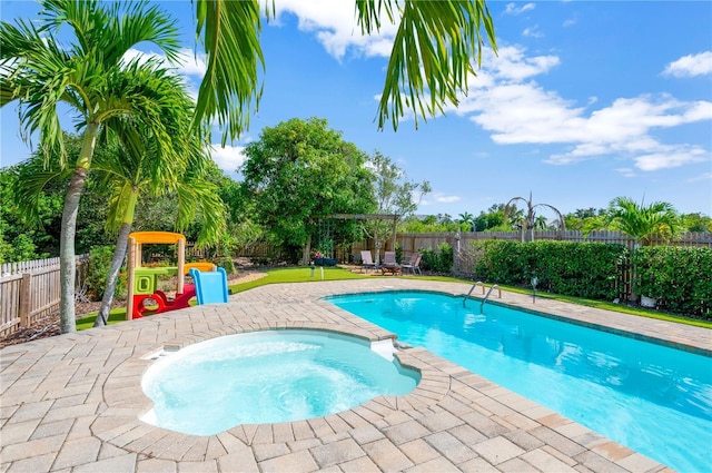 6419 Marbella Blvd, Apollo Beach, FL 33572 - view of pool featuring a fenced backyard, a patio area, and a pool with connected hot tub