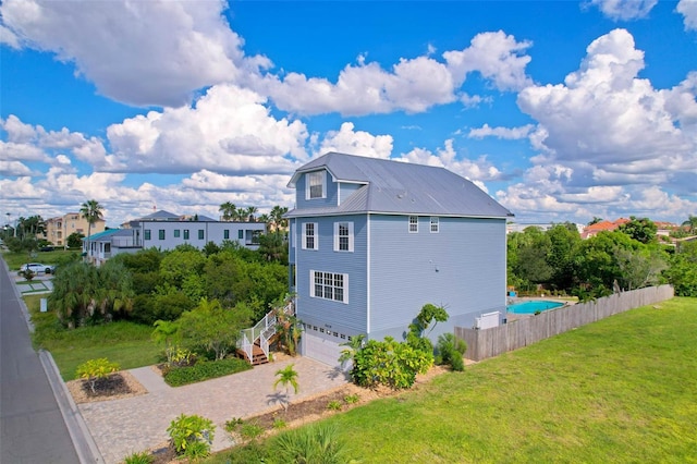 6419 Marbella Blvd, Apollo Beach, FL 33572 - view of property exterior with an attached garage, metal roof, and driveway