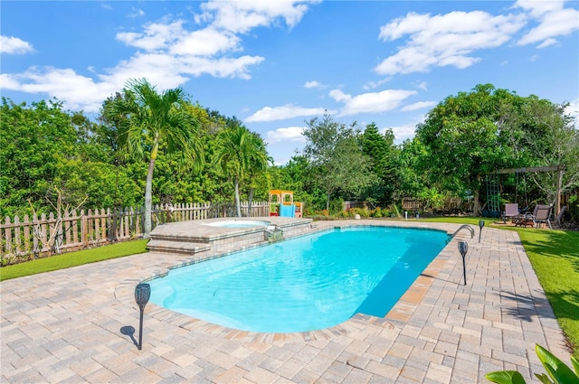 6419 Marbella Blvd, Apollo Beach, FL 33572 - view of swimming pool featuring a fenced backyard, a patio area, view of wooded area, and a pool with connected hot tub