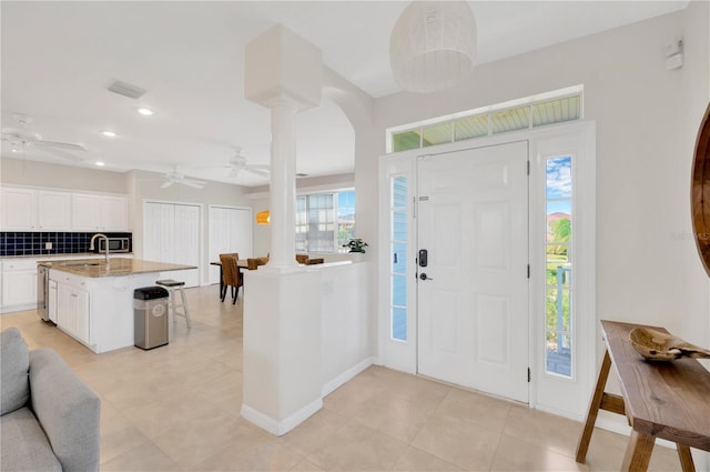 6419 Marbella Blvd, Apollo Beach, FL 33572 - foyer entrance with ornate columns, ceiling fan, light tile patterned floors, recessed lighting, and baseboards