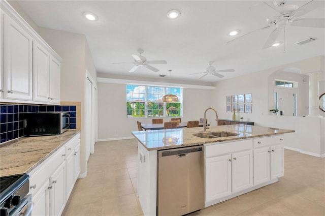 6419 Marbella Blvd, Apollo Beach, FL 33572 - kitchen with appliances with stainless steel finishes, a sink, a ceiling fan, baseboards, and a kitchen island with sink