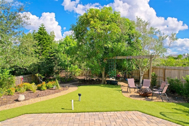 6419 Marbella Blvd, Apollo Beach, FL 33572 - view of yard featuring an outdoor fire pit and a patio area