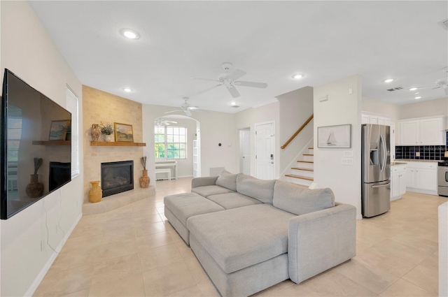 6419 Marbella Blvd, Apollo Beach, FL 33572 - living area featuring ceiling fan, a large fireplace, recessed lighting, light tile patterned floors, and stairway