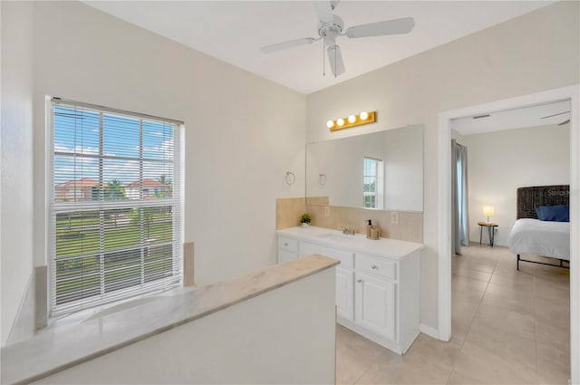 6419 Marbella Blvd, Apollo Beach, FL 33572 - ensuite bathroom with vanity, tile patterned flooring, ceiling fan, backsplash, and baseboards
