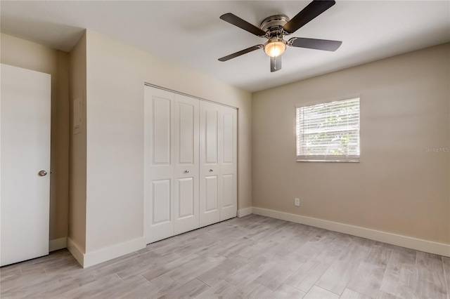 unfurnished bedroom featuring light wood-type flooring, ceiling fan, and a closet