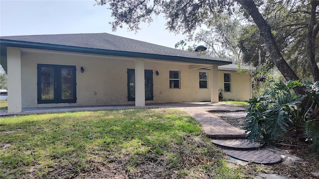 rear view of property with a yard and french doors