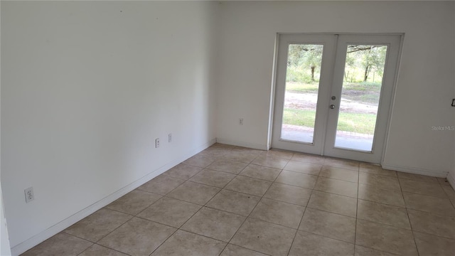 interior space with french doors, light tile patterned floors, and a healthy amount of sunlight