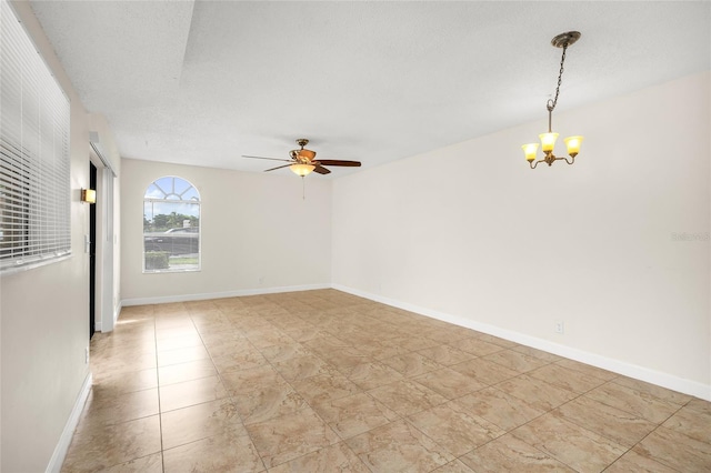 spare room featuring baseboards, a textured ceiling, and ceiling fan with notable chandelier