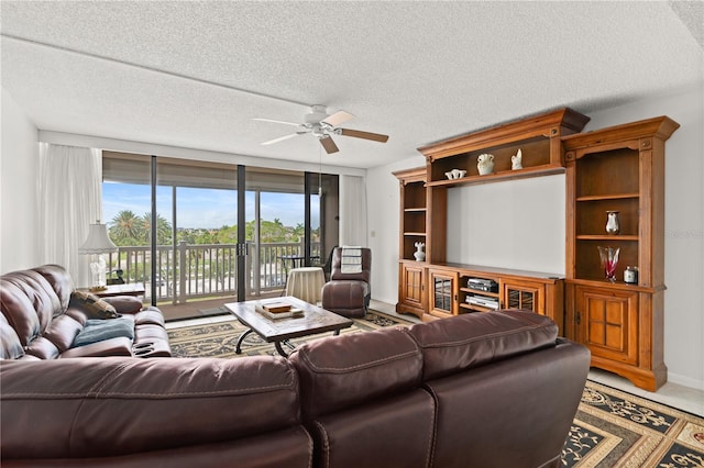 living room featuring a textured ceiling and ceiling fan