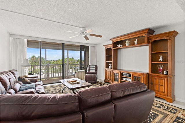 500 Treasure Island Cswy Unit 406, Treasure Island, FL 33706 - living room with a textured ceiling, floor to ceiling windows, baseboards, and a ceiling fan