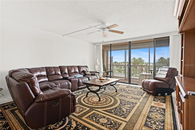 living room featuring a textured ceiling, floor to ceiling windows, and ceiling fan