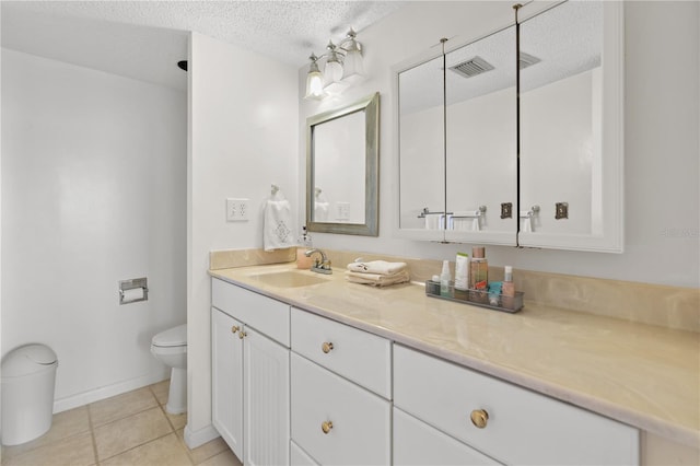 bathroom featuring tile patterned floors, toilet, a shower, vanity, and a textured ceiling