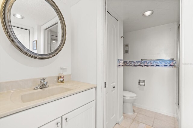 bathroom featuring tile patterned floors, toilet, and vanity