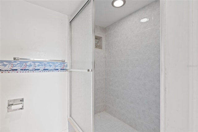 bathroom with tiled shower