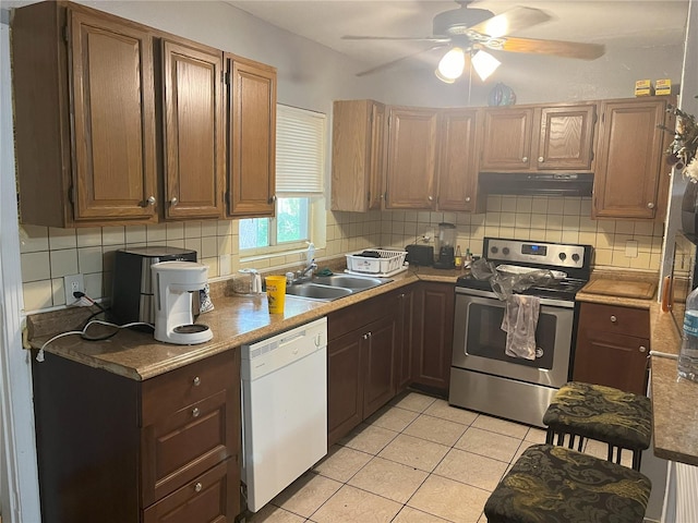 kitchen featuring stainless steel range with electric stovetop, tasteful backsplash, white dishwasher, ceiling fan, and light tile patterned flooring