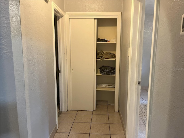 hallway with light tile patterned flooring