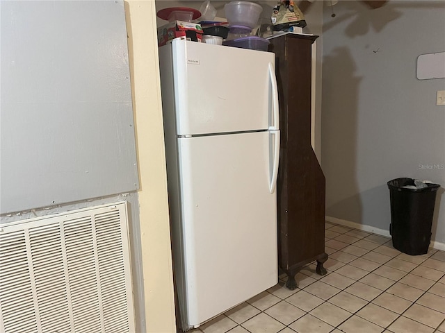 kitchen with white fridge and light tile patterned floors