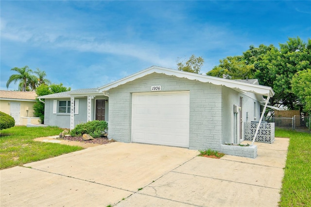 single story home featuring a garage and a front lawn