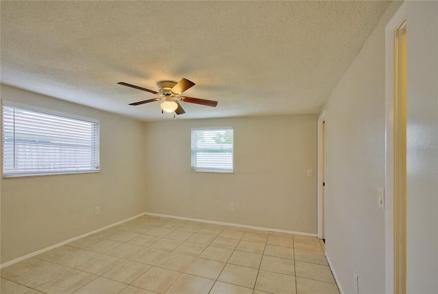 tiled spare room featuring ceiling fan and a textured ceiling