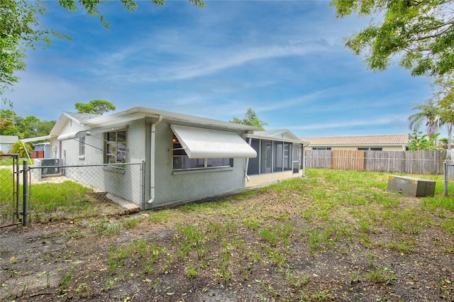 view of side of home featuring a sunroom and central AC unit