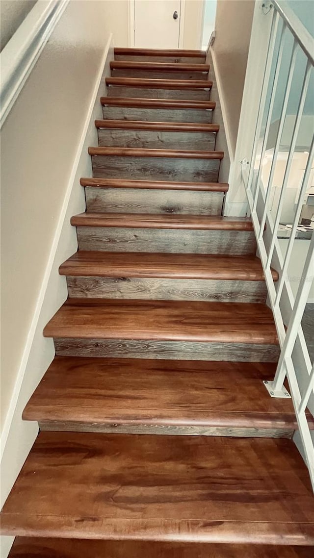 stairway featuring wood finished floors