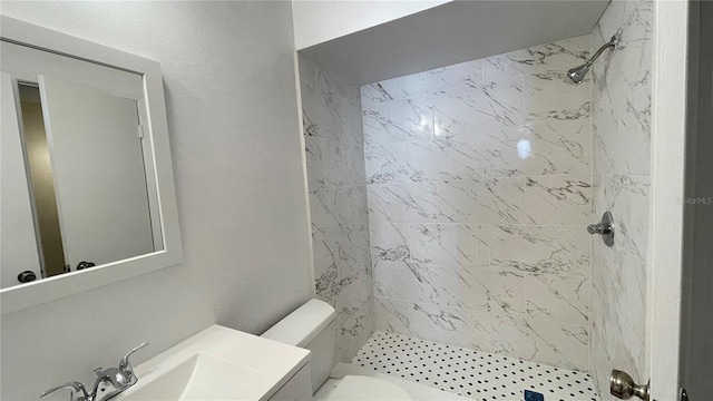 full bath featuring a shower stall, toilet, vanity, and a textured wall