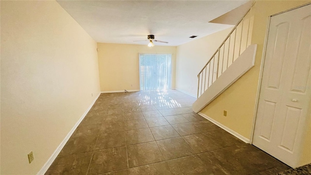 spare room with visible vents, tile patterned flooring, baseboards, ceiling fan, and stairs