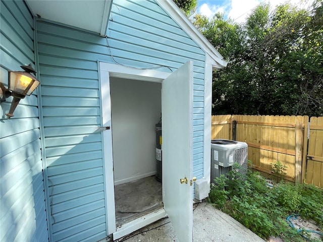 exterior space featuring central air condition unit and fence