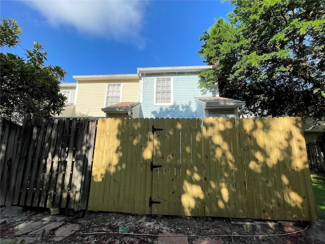 view of side of home featuring fence