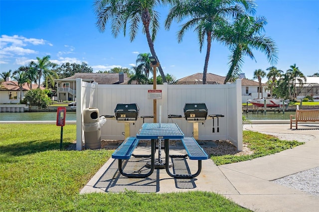 exterior space featuring a lawn and a water view