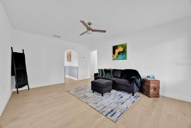 living room with ceiling fan and light wood-type flooring