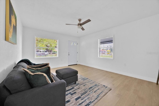 living room with hardwood / wood-style flooring and ceiling fan