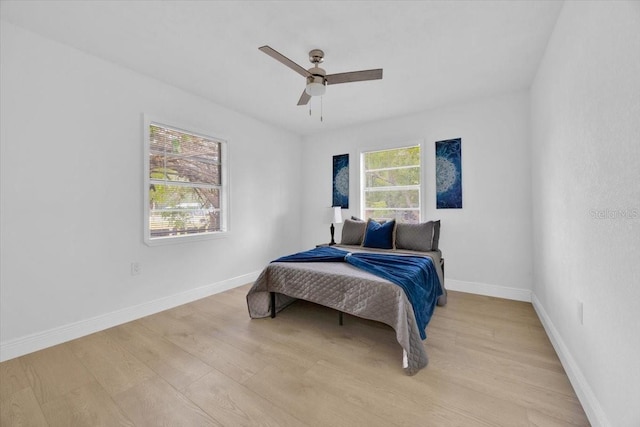 bedroom with ceiling fan and light hardwood / wood-style flooring