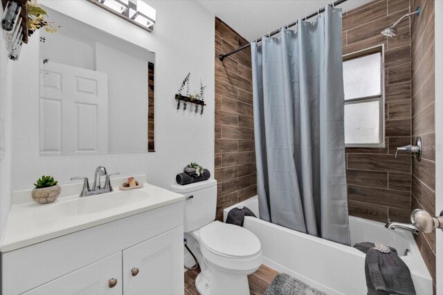 full bathroom with vanity, shower / tub combo with curtain, toilet, and hardwood / wood-style flooring