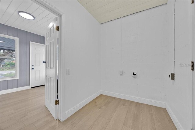 interior space featuring wooden walls and light wood-type flooring