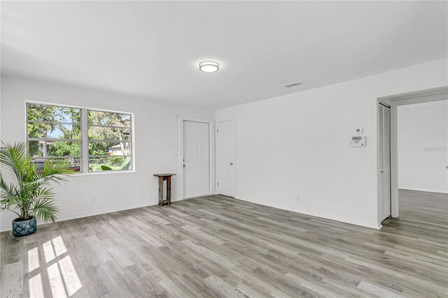 spare room featuring light wood-type flooring