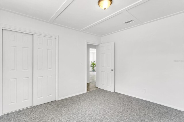 unfurnished bedroom with a closet and carpet