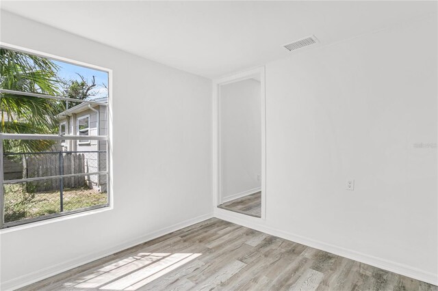 spare room with light hardwood / wood-style flooring