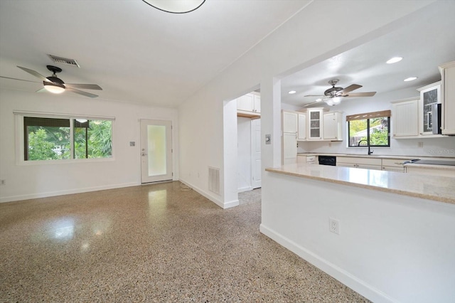 kitchen featuring white cabinetry, a healthy amount of sunlight, and sink