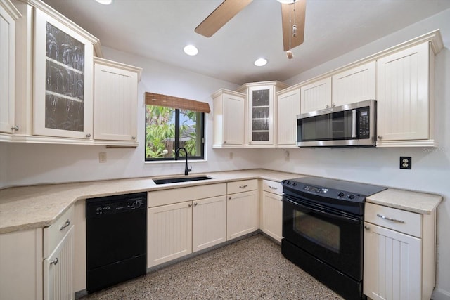 kitchen featuring black appliances, ceiling fan, and sink