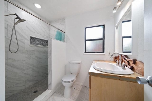 bathroom with a shower with shower curtain, vanity, and toilet