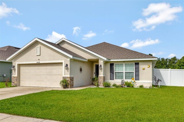 view of front of property featuring a front lawn and a garage