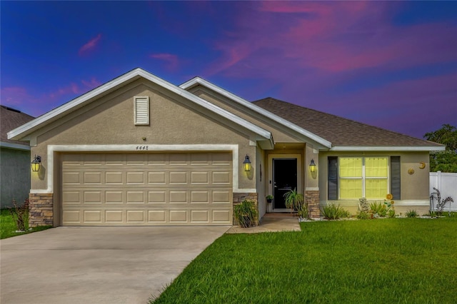 view of front facade with a garage, stone siding, and stucco siding